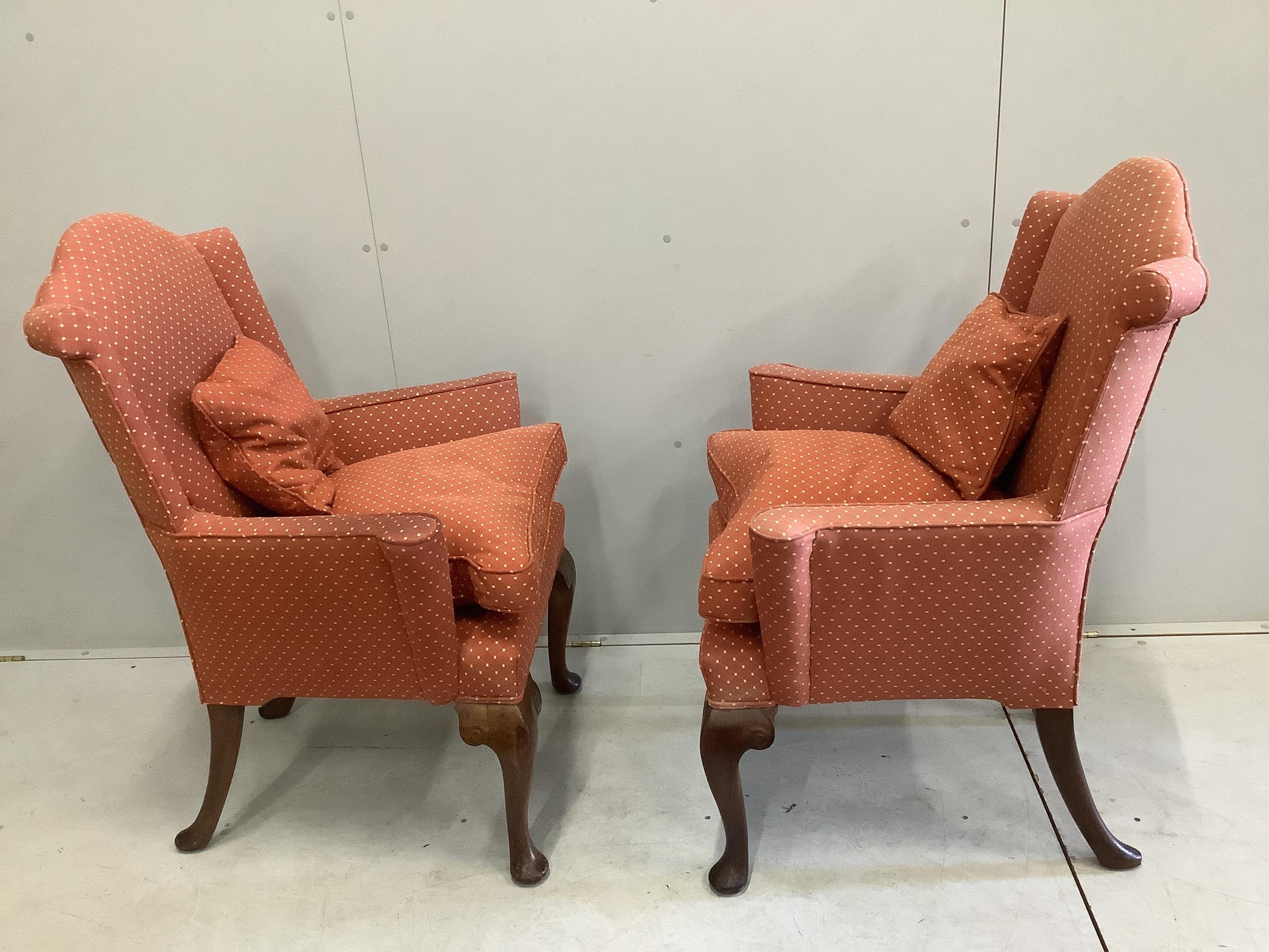 A pair of 1930's Queen Anne Revival walnut armchairs, width 78cm, height 107cm. Condition - slight fading to the top of the upholstery, minor rubbing to legs, fair to good